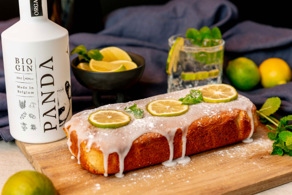 A loaf of cake with limes on a cutting boardDescription automatically generated
