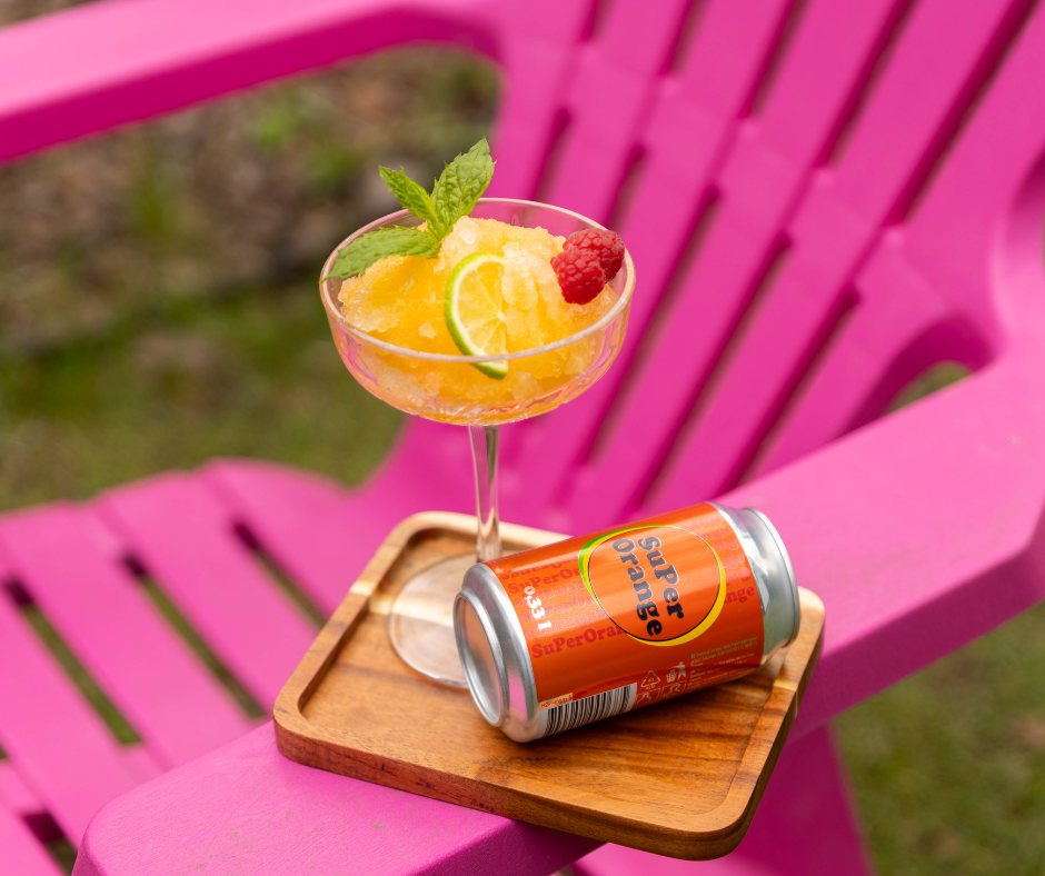 A drink and a can on a pink chairAI-generated content may be incorrect.